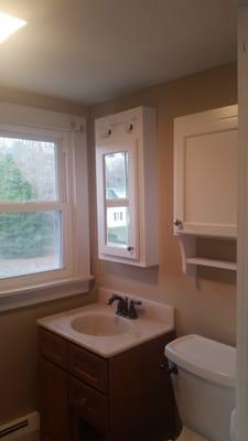 The cabinets prior to installing the shades. The cabinet with the mirror looks like a mini version of the window.