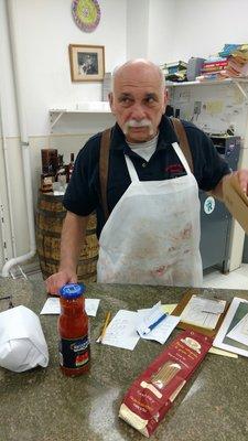 Joe the Butcher packing up some Italian specialties and ground prime beef.