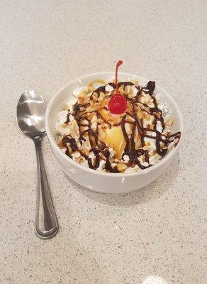 Classic Sundae- vanilla ice cream with whipped cream, peanuts, a cherry and your choice of topping: fudge, caramel, or butterscotch.