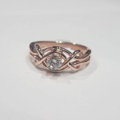 14j rose gold "love knot" design ring with .30ct round brilliant cut diamond