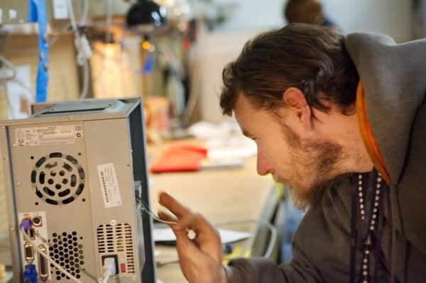 A volunteer refurbishes a donated computer.