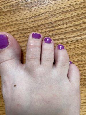 Toes were not filed and cuticles not taken care of. Messy paint and uneven nails