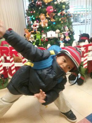 My 4 year old posing on front of his favorite Christmas decorations at A to Z! He stops , looks and posed!