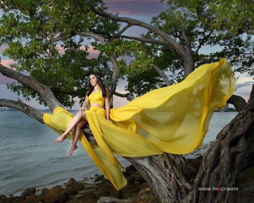 Quinceanera photo session on the Miami beach at sunset, wearing a beautiful yellow fancy dress.