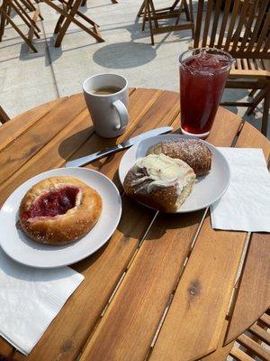 Kolache, chocolate croissant, cinnamon roll with coffee and ice tea of the day, peach hibiscus