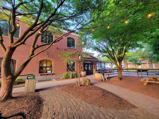 Entrance with patio/outdoor seating.