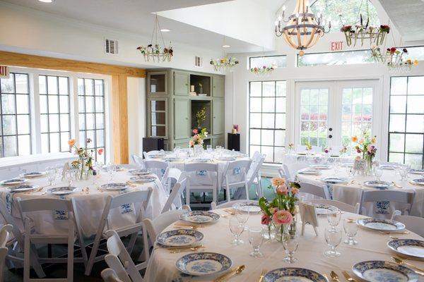 Lots of light wedding in the Farmhouse event venue. Blue and white plates with wildflowers.