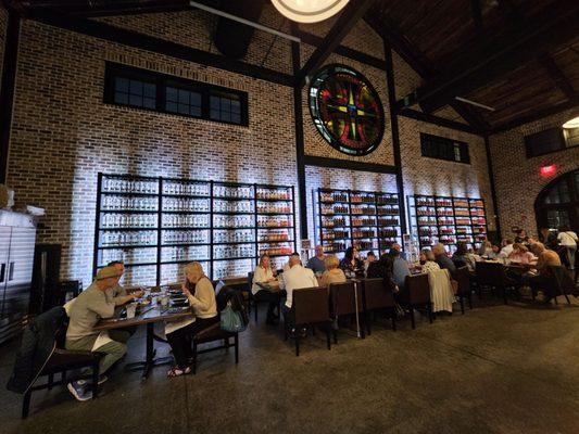 Table seating against backdrop of bourbon bottles for purchase.