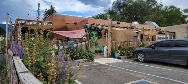 View from the parking lot on the side of the building. Outdoor seating is at left