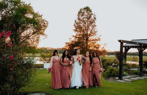 Golden hour highlights this picture of this beautiful bride and her bridesmaids.