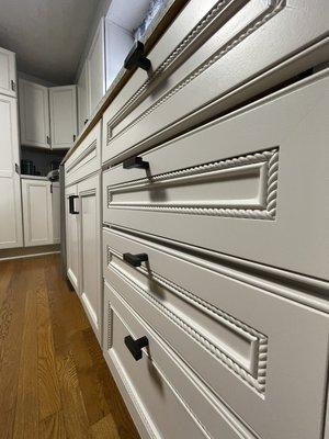 Close up American cherry cabinets painted to show smooth grain