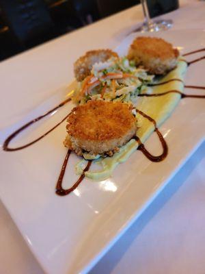 Crab cakes with wasabi sauce.