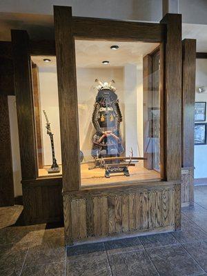 A glass display case with a Japanese item.