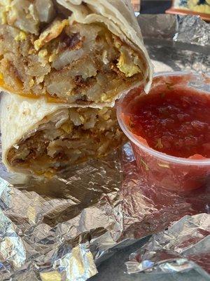 Breakfast burrito - bacon, homestyle potatoes, cheese, and eggs with a side of salsa