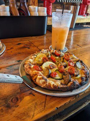 Ratatouille pizza made with vegan cheese and a custom mocktail