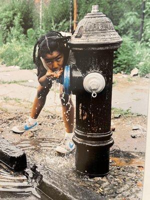 Girl drinking from a fire hydrant. Jamel Shabazz - A Time Before Crack