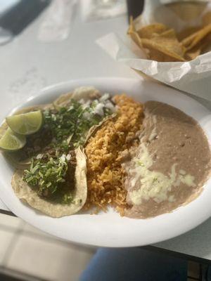 Carne Asada tacos, with rice and beans.