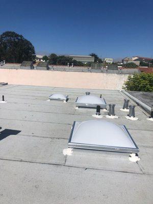 A new roof installation of torchdown smooth and granulate with 3 new skylights