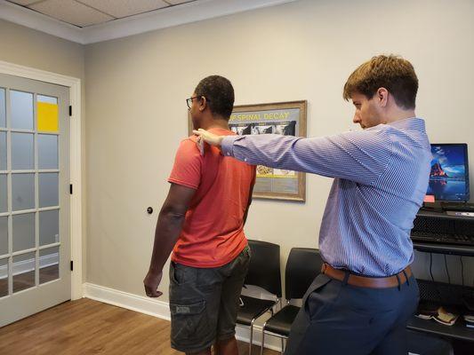 Hands on posture and spinal exam.