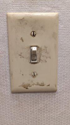 Filthy, disgusting light switch in the filthy, disgusting Pepper Mill.