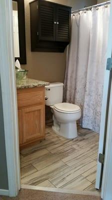 Our guest bathroom originally had white plain laminate. We had it replaced with this great looking tile that matched perfectly!