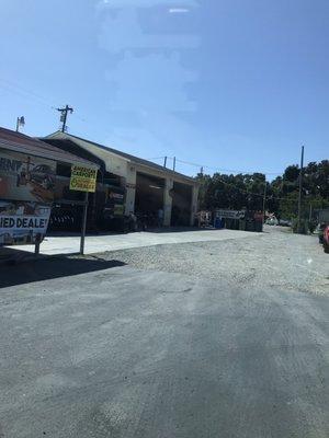 No customers as you can see! But look Close everyone is sitting around a table in the bay garage.