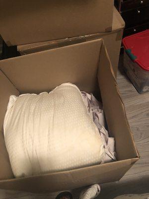 2 pillows packed in a box stuffed with paper. The top was stuffed with paper too - I took it out. This is insane!