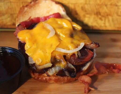 Billy's BBQ Burger: Topped with Cheddar Cheese, Bacon, Grilled Onions and smothered in BBQ Sauce.