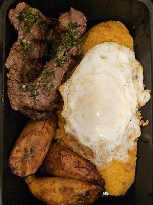 Bistec a lo Pobre. Rice and beans together, a fried egg, a tender and juicy steak, fried sweet ripe plantains, and a criolla sauce.