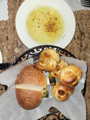 Complimentary bread, garlic knots, and olive oil.