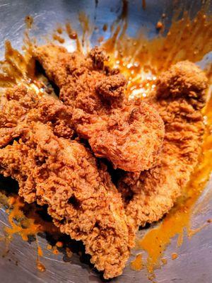 Hand battered chicken tenders before the toss