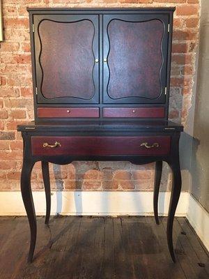 Refinished secretary done with black over red milk paint.