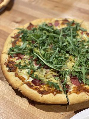 Our BYO pizza: white sauce, thick crust, with artichoke hearts, prosciutto and arugula on top.