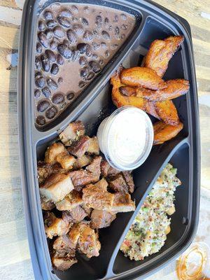 Porchetta platter with sweet plantains, black beans and slaw