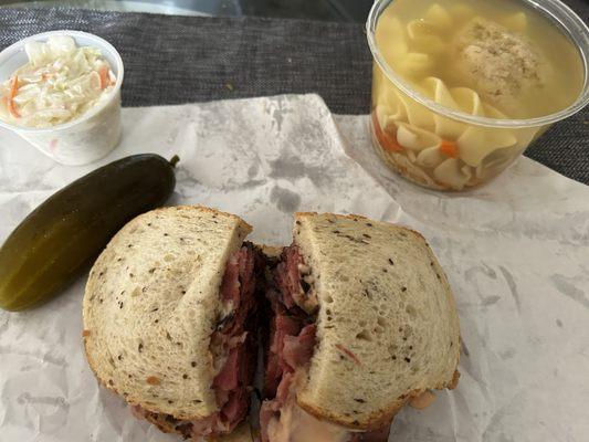 Matzo Ball Soup & Pastrami Sandwich on rye with Russian dressing, Cole slaw, and a dill pickle.