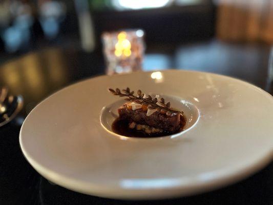 Pork Shank with sea buckthorn, pork tuile, pearl onion, and steel cut oat porridge