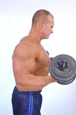 owner Mark Metzger doing dumbbell curls