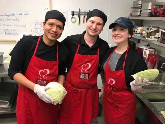 Kitchen Volunteers helping cut cabbage!