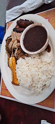 White rice with black beans, roast pork and queso frito.