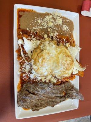 Chilaquiles with red sauce and steak.... Yum!