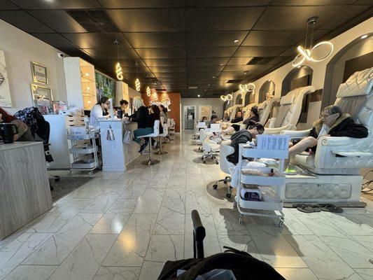 Long view of the pedicure chairs and the nail "bar"  Quality Clean and Classy!