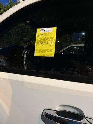 Sticker on drivers glass, stating the demands of the extortionist.