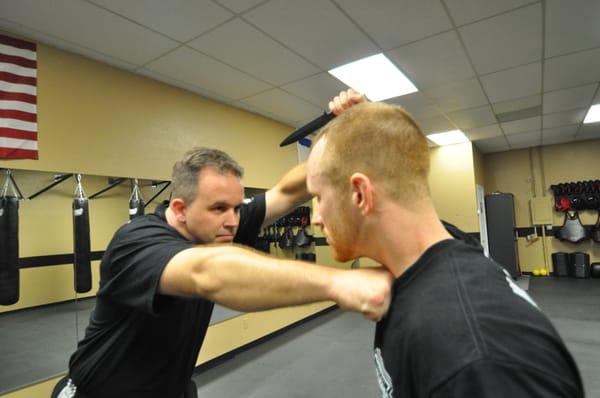 Owners Brian Peters (Left) and Joseph Battle (right) executing knife defense technique.