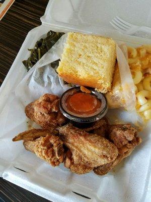 Fried chicken wings,  greens, mac & cheese, yams, and cornbread