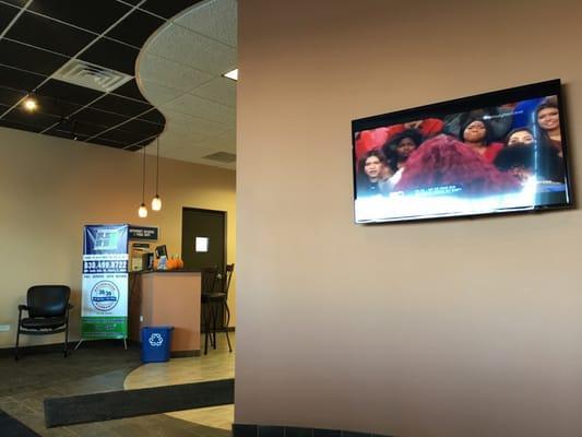 Waiting area with comfortable chairs and tv.