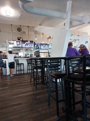 Inside view, with bar and TVs in background