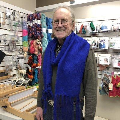 Cliff models his first handwoven scarf.