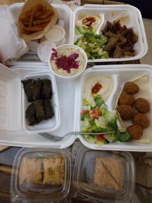 Takeout falafel & gyro plate with baklava, grape leaves, baba ganoush & fries on the side