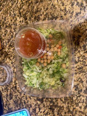 Container of lettuce. Some garbanzos and lots of dressing.