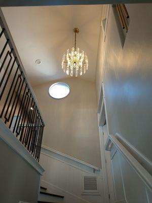 New installation of costumer supply Chandelier over stairway